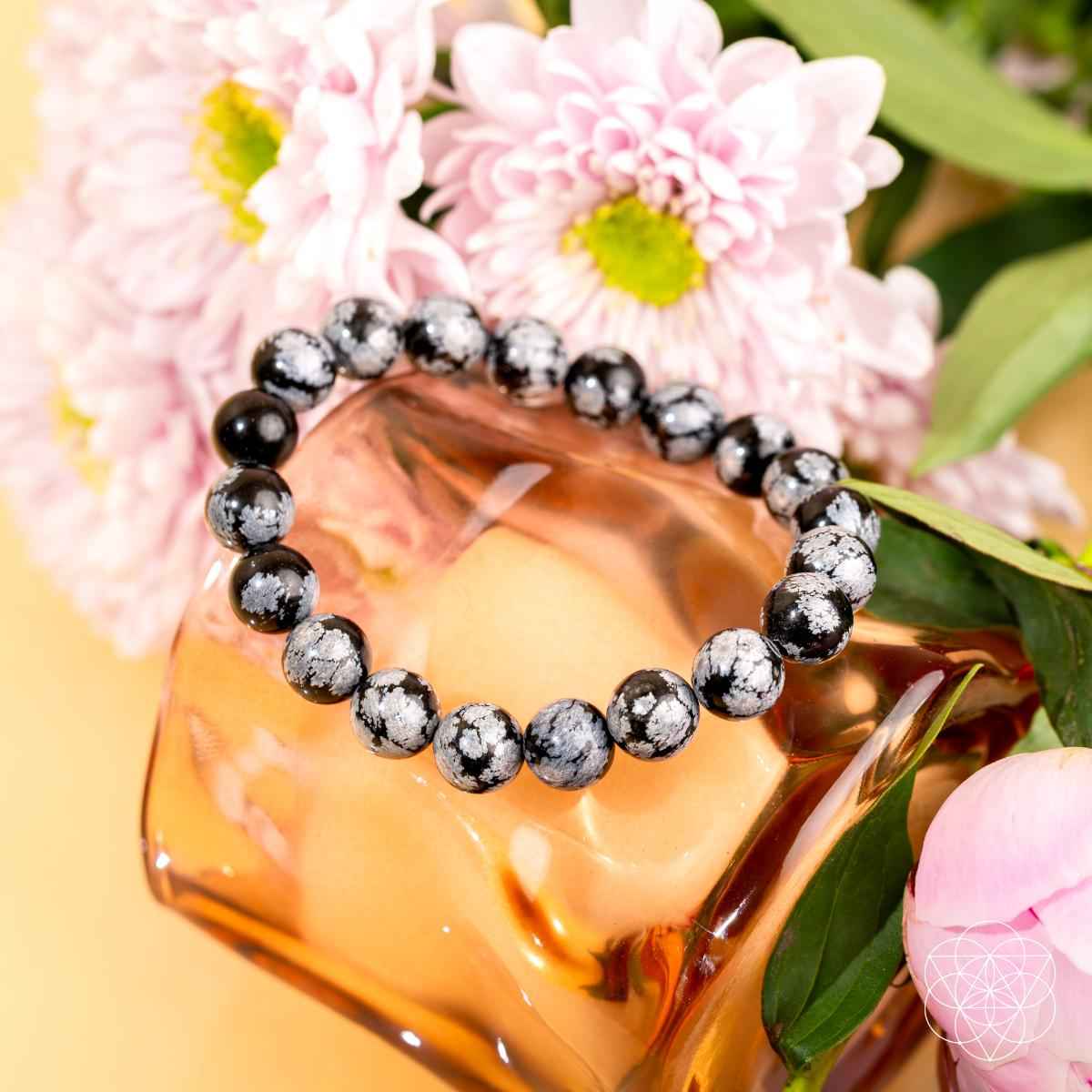 Snowflake obsidian bracelet with black and gray speckled round beads, close view