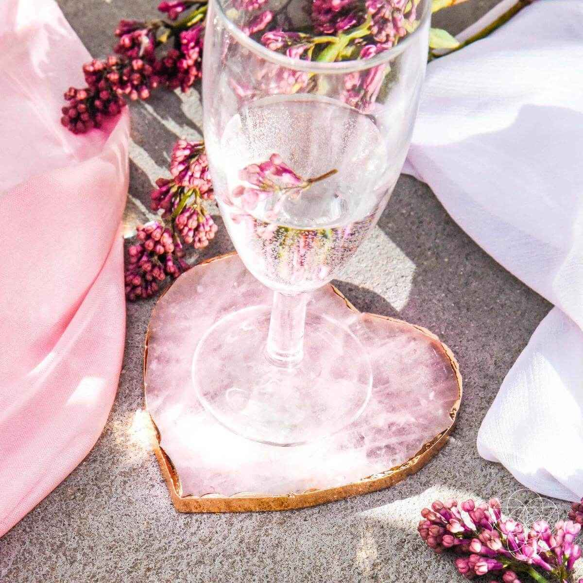 Pink heart-shaped marble coaster with gold edge under a wine glass; set of 2