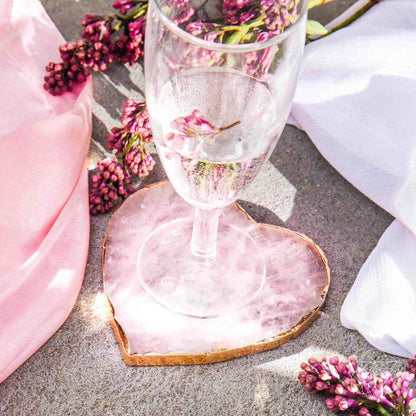 Pink heart-shaped marble coaster with gold edge under a wine glass; set of 2
