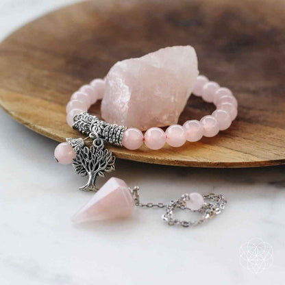 Rose quartz crystal set featuring bead bracelet, tree charm pendant, and raw stone