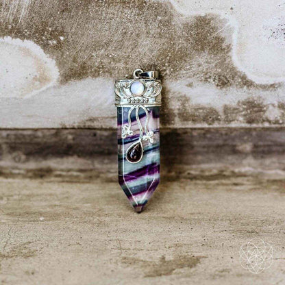 Purple-blue striped crystal pendant with silver-tone cap and moonstone detail