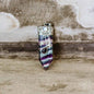 Purple-blue striped crystal pendant with silver-tone cap and moonstone detail