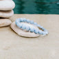 Sky-blue bead bracelet with round stones, flexible elastic string.