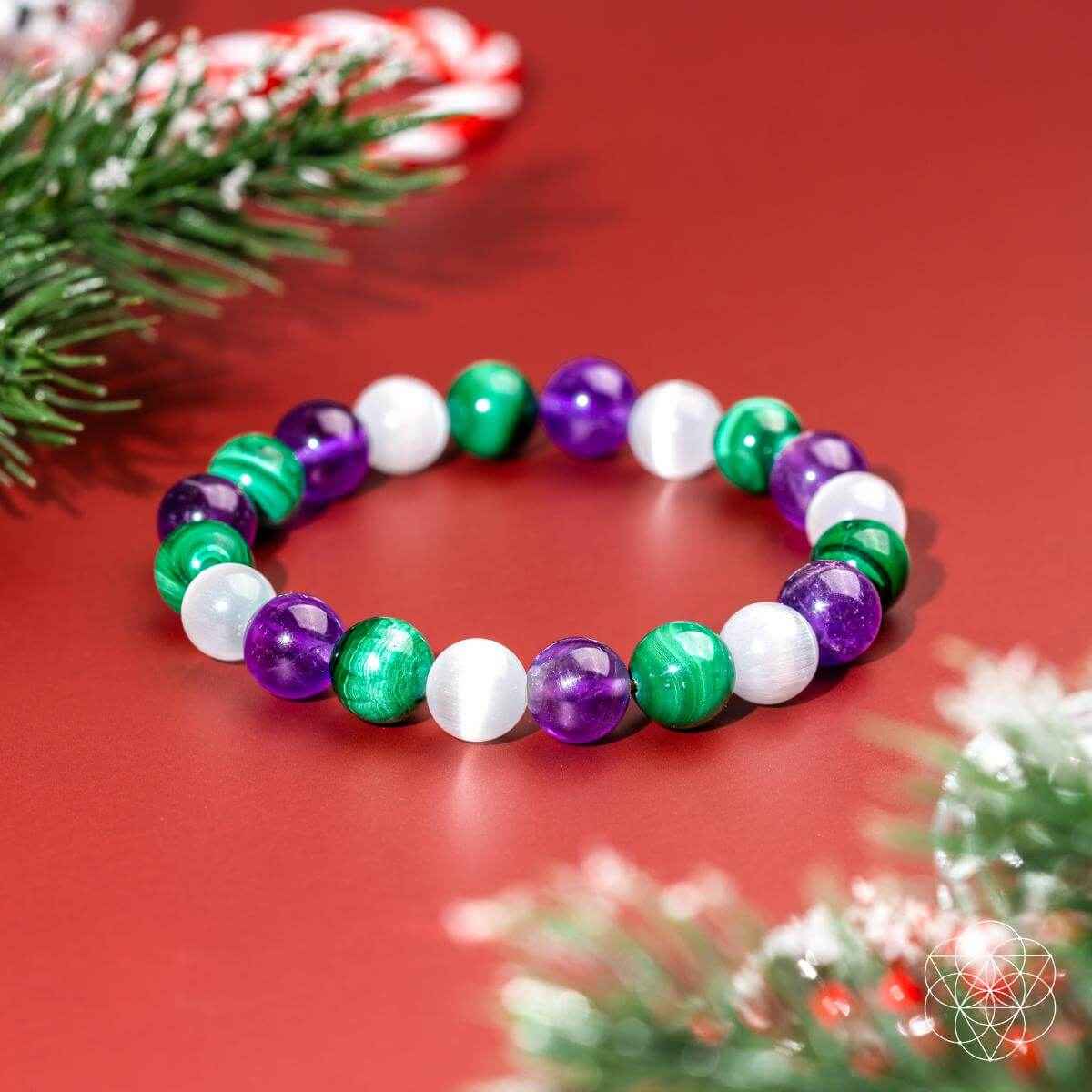 Healing bracelet with alternating green, purple, and white beads, shown front view