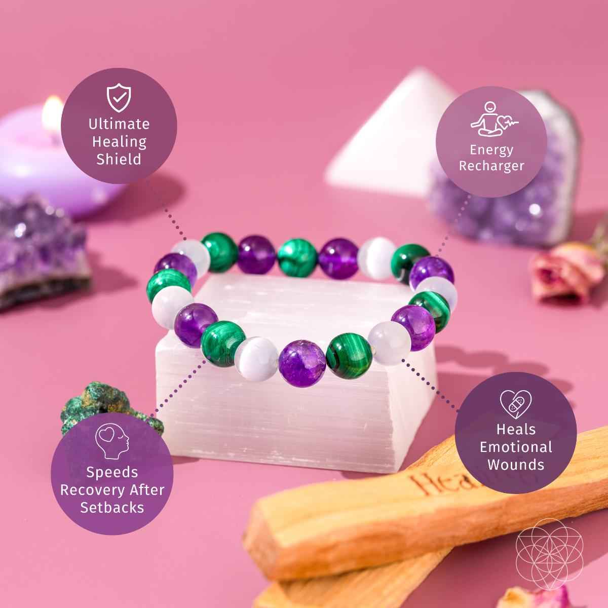 Healing bracelet with green and purple beads and white spacers on a display stand