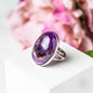 Silver ring with oval purple gemstone, polished bezel setting