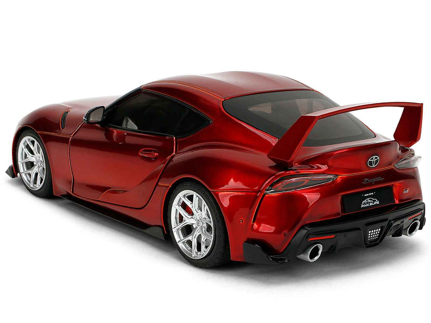 Red metallic Toyota GR Supra diecast model car with rear spoiler and dual exhaust