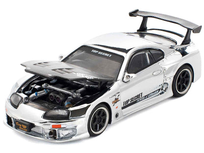 Silver and black Toyota Supra diecast race car with open engine bay and front decals