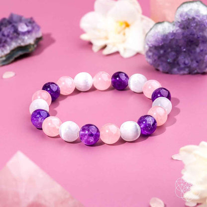 Beaded bracelet with pink, white, and purple round stones in a trinity pattern.