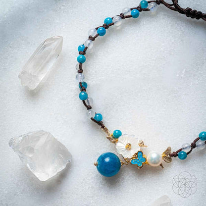 Blue beaded anklet with crystal bead, pearl, and gold flower charm
