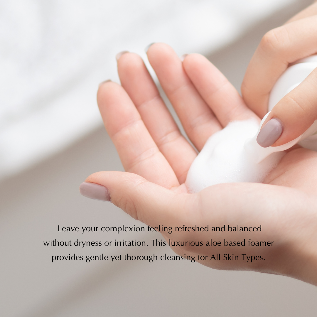 Gentle foaming facial cleanser on open palm with white lather