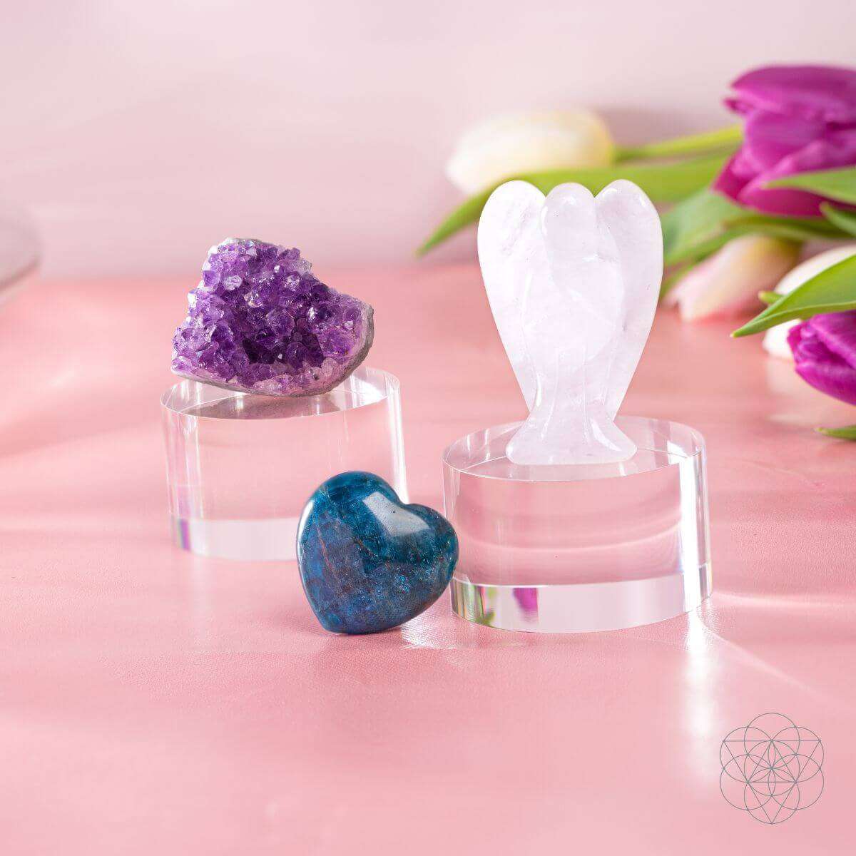 Car crystal charm accessories: white heart statue, purple geode, and blue heart in clear holders