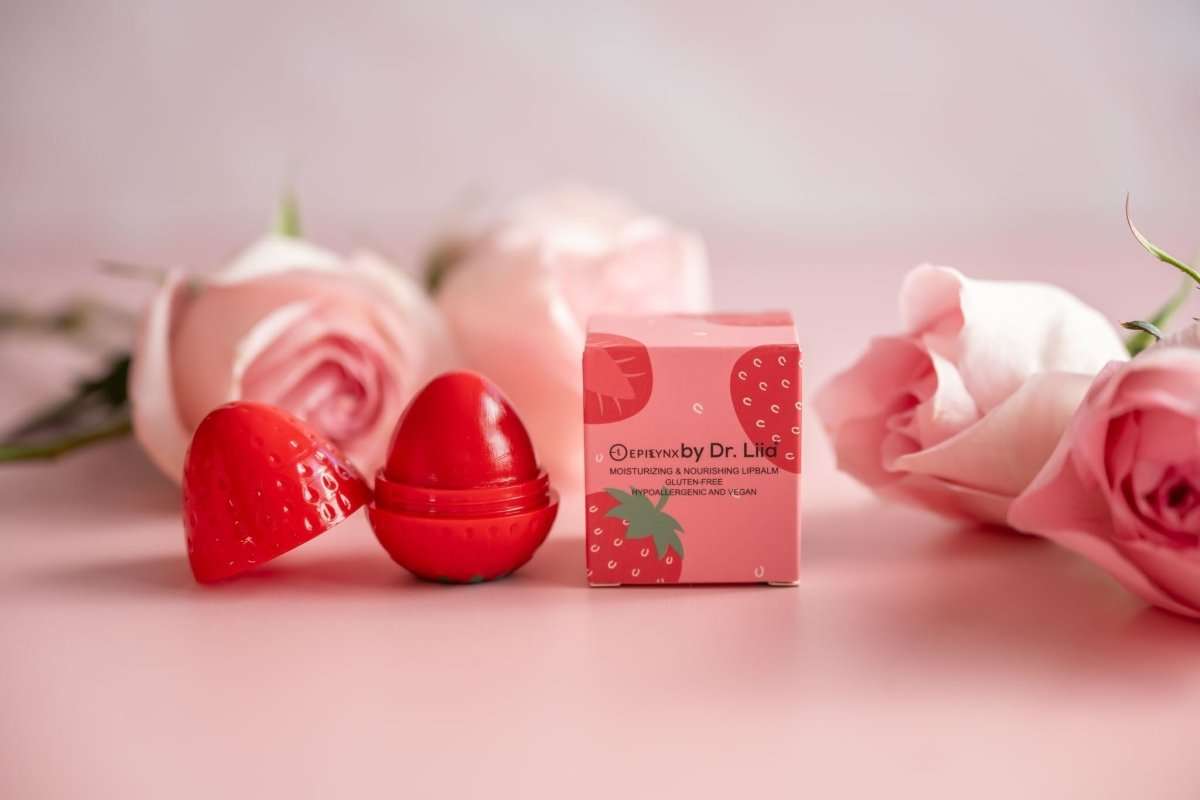 Red strawberry lip butter balm and product box with roses and strawberries shown