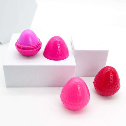 Pink and red strawberry-shaped lip butter set with several capped containers.