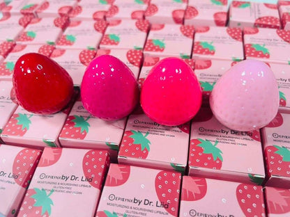Strawberry-shaped lip butter containers in red and pink with product boxes.
