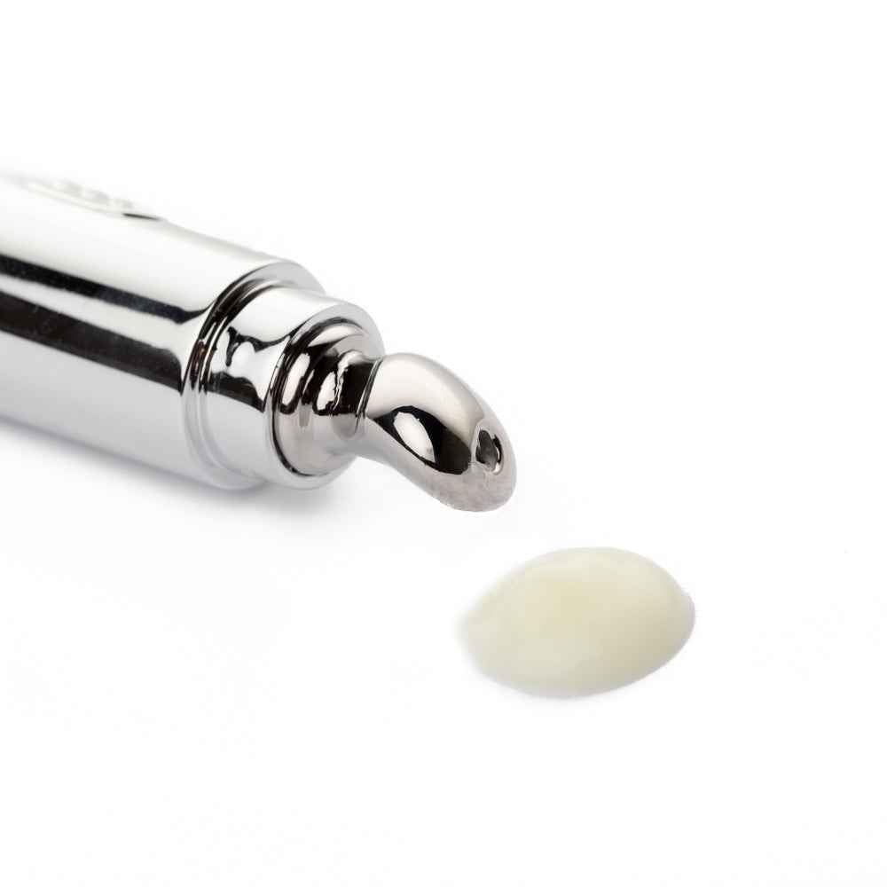 Eye cream applicator tube with chrome roller tip and small dollop of cream