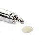 Eye cream applicator tube with chrome roller tip and small dollop of cream