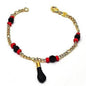 Gold-filled charm bracelet with red beads and black hanging charm