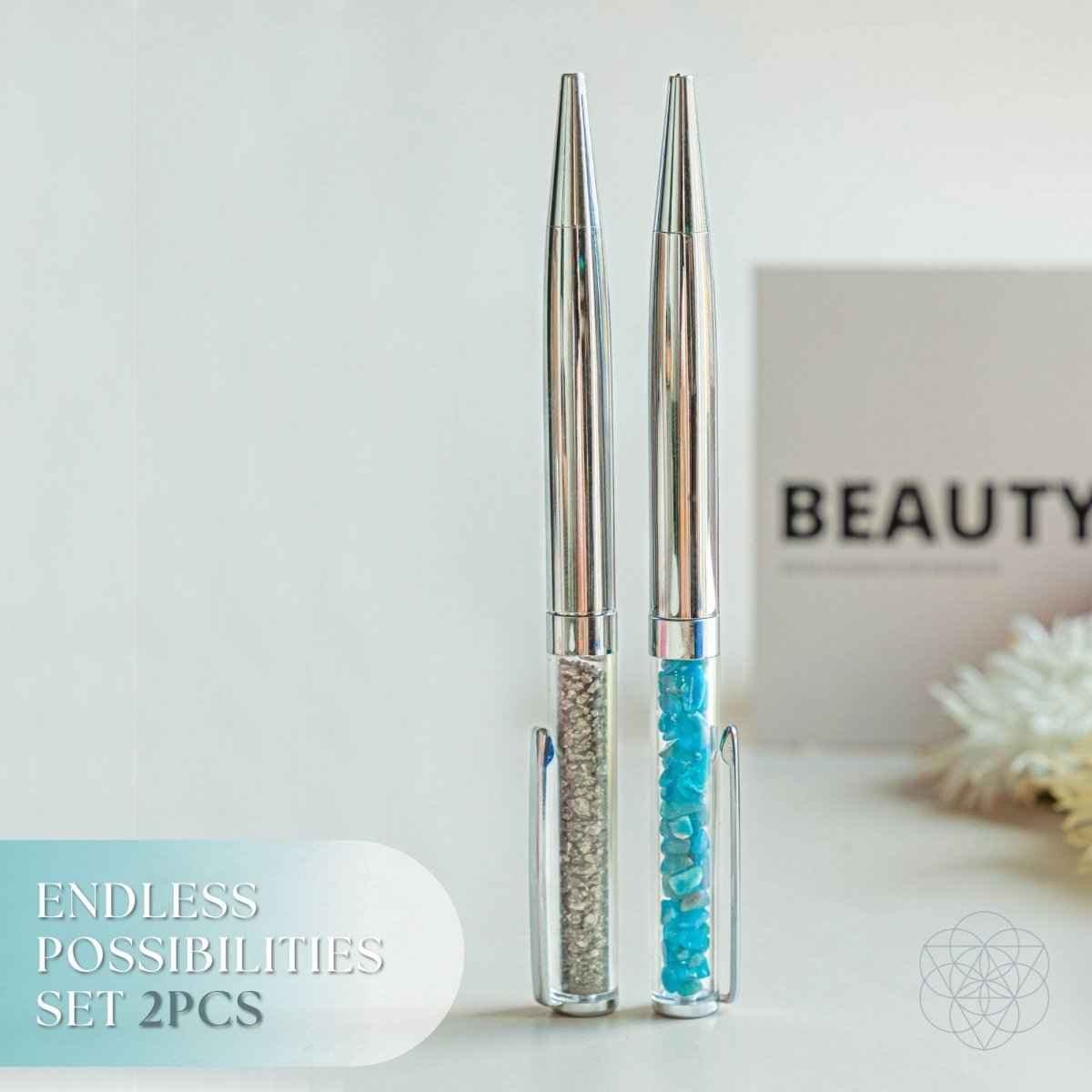 Manifestation pen set with two metallic pens, one with blue and one with teal glitter