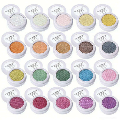Assorted shimmer eyeshadow compacts in round white cases