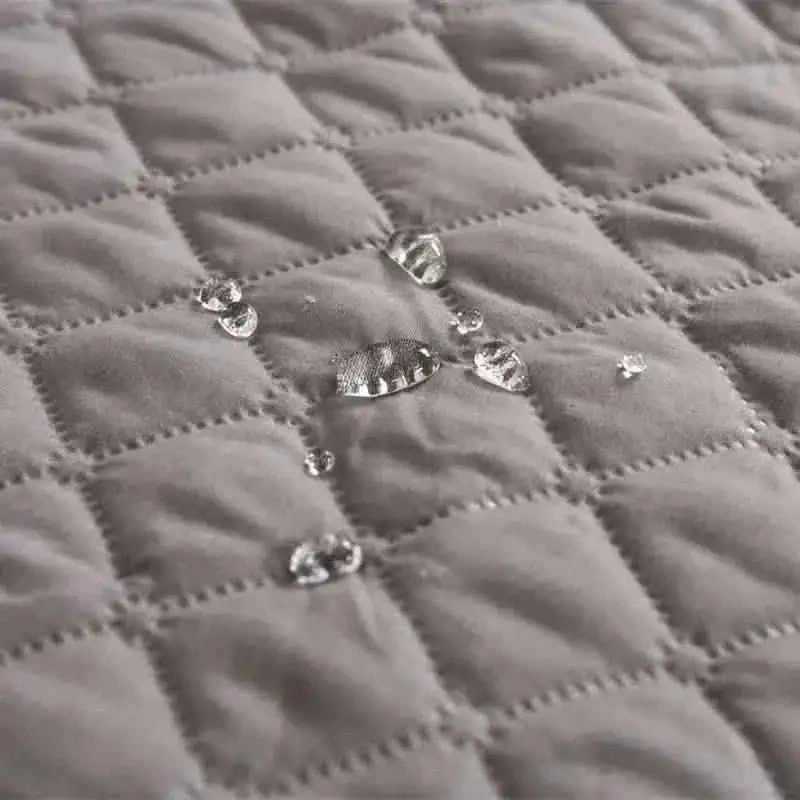 Pet bed cover quilted fabric close-up with shiny snap buttons