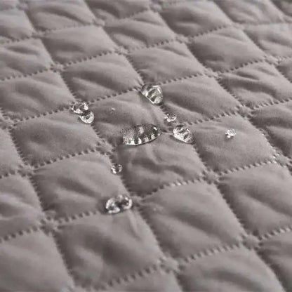 Pet bed cover quilted fabric close-up with shiny snap buttons