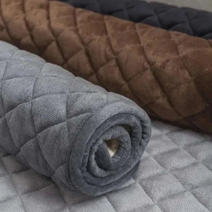 Pet bed cover, gray quilted fabric close-up with rolled edge texture.