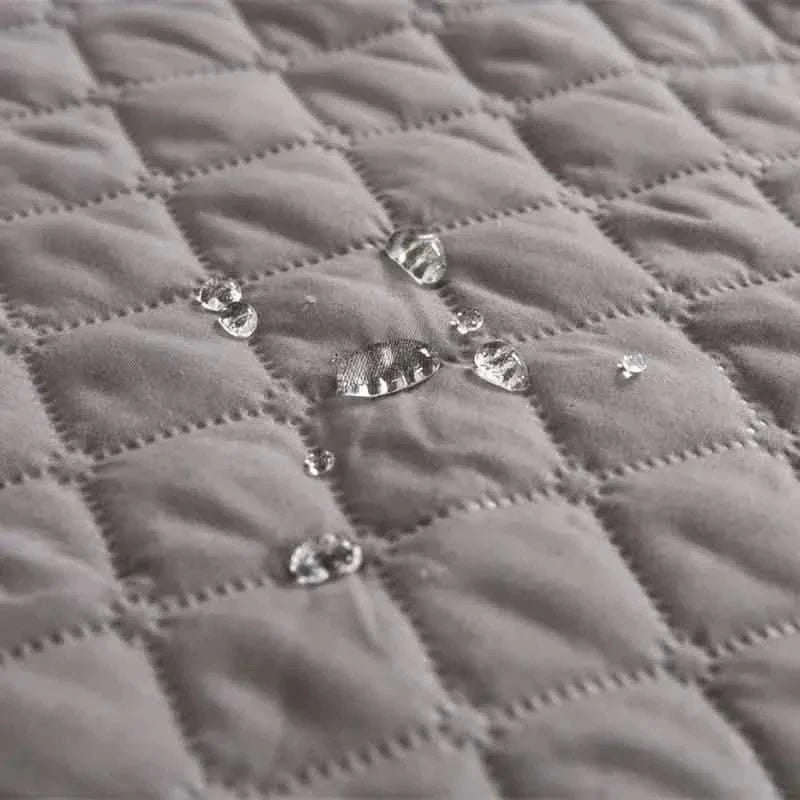 Pet bed cover, gray quilted fabric with visible snap buttons close-up.