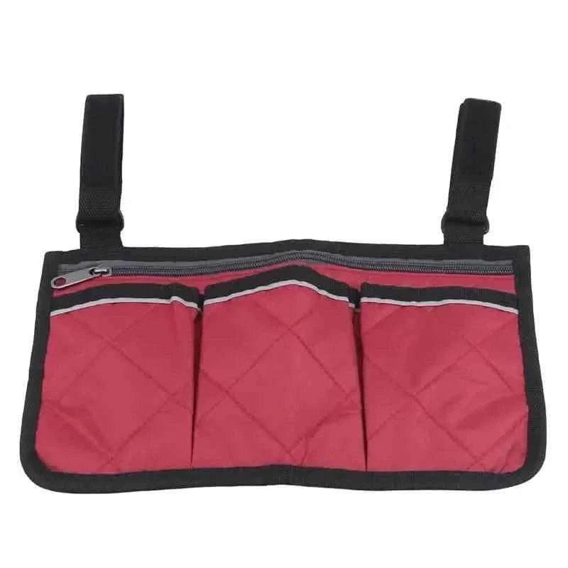 Red wheelchair armrest organizer bag with three front pockets and black edge trim.