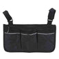 Black wheelchair armrest organizer bag with three pocket panels and top zipper.