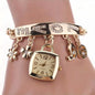 Gold square-face charm bracelet watch with crystal letter links, heart and flower charms
