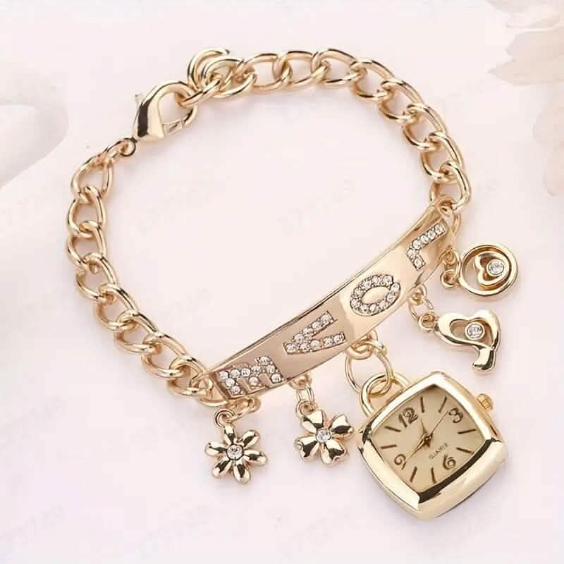 Gold tone charm bracelet watch with square face and flower charms along link band