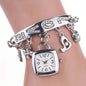 Silver tone charm bracelet watch with square face, crystal letter links and flower charms