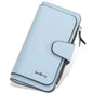 Light blue faux leather wallet with fold-over tab, card slots, and zipper pocket