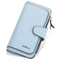 Light blue faux leather wallet with fold-over tab, card slots, and zipper pocket