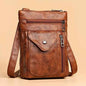 Brown vintage leather crossbody bag with flap, front pocket, and two zippers