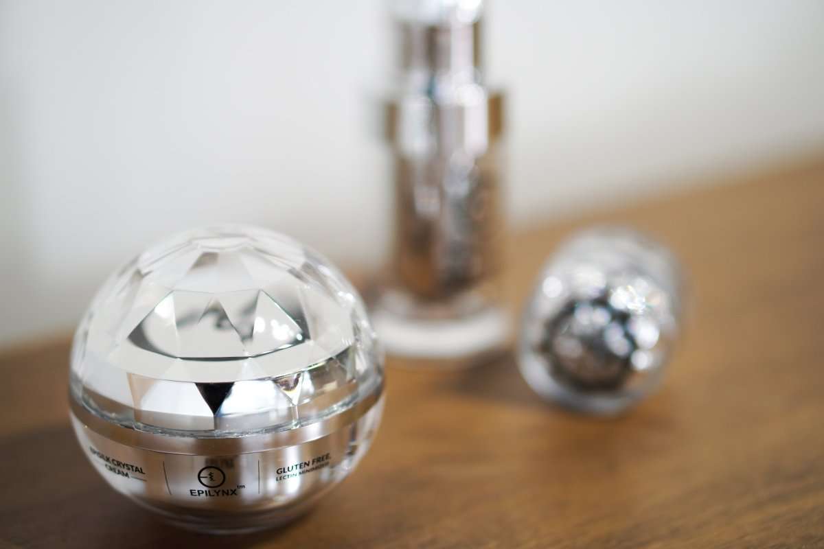 EpiLynx crystal-style jar and bottle skincare set on a vanity