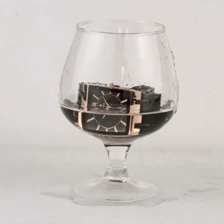 Square black wristwatch with gold accents, black metal bracelet and bezel