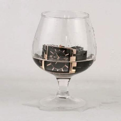 Square black wristwatch with gold accents, black metal bracelet and bezel